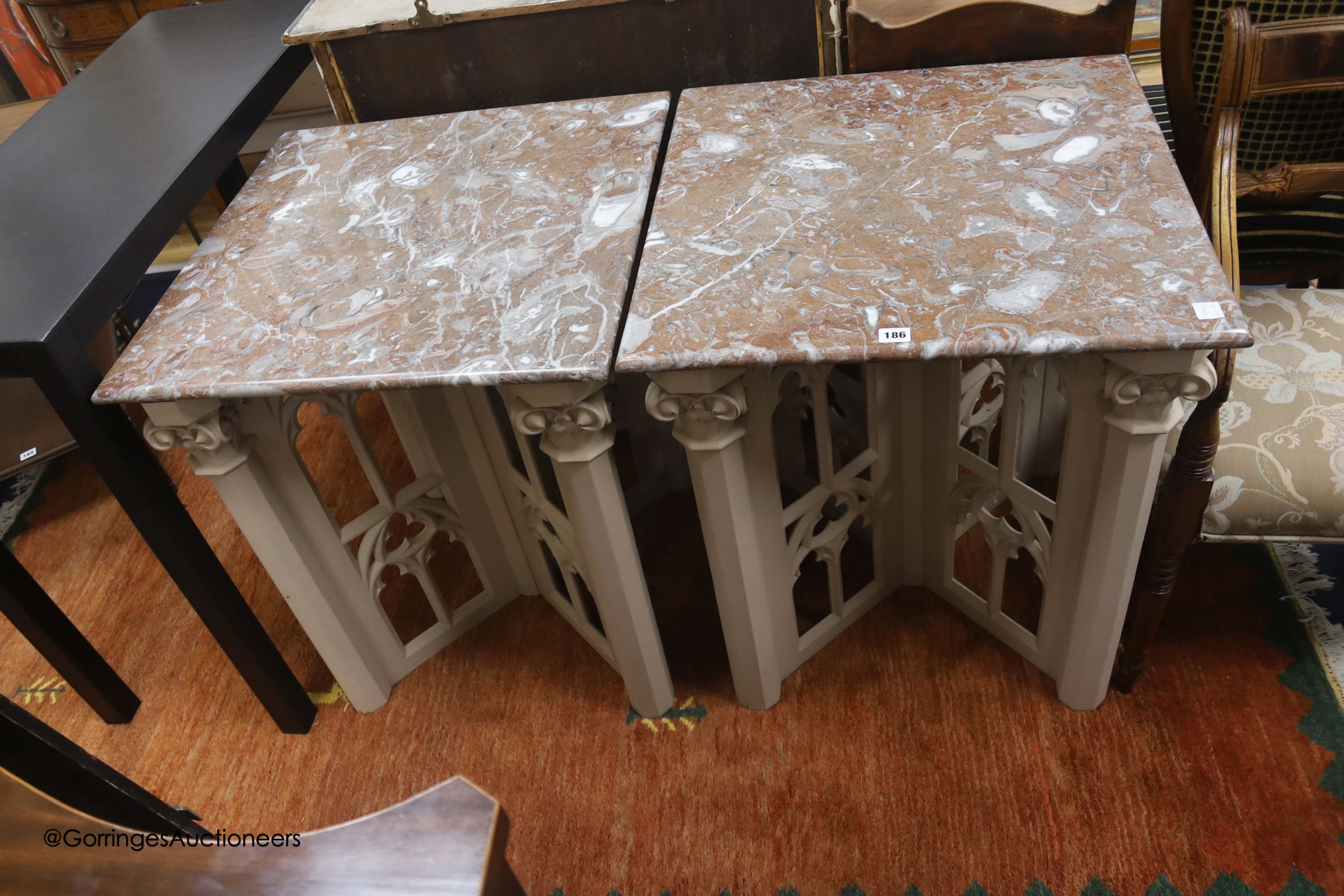 A pair of modern square tables in Gothic style, marble tops